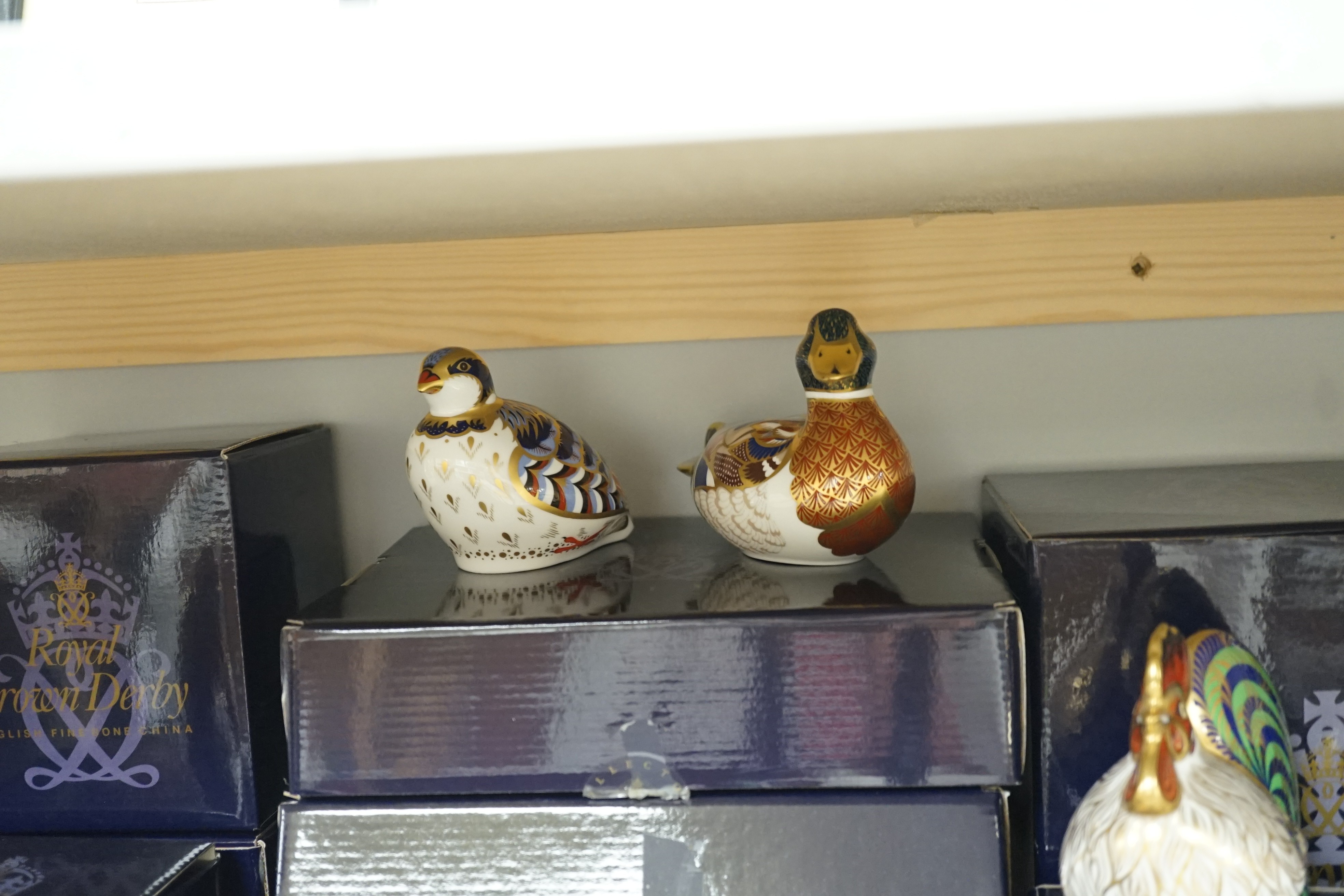 Approximately thirty-two Royal Crown Derby Imari porcelain paperweights, all but two with original boxes and mostly gold bottoms